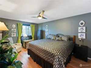 Spacious primary bedroom with freshly painted surfaces, LVP flooring, lovely decor and furnishings. Everything you need for a great night's sleep...including the sea breezes!