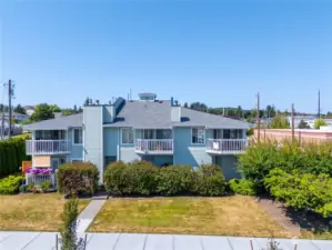 Nice building with lawn, balcony to enjoy the water, island and Mt. Baker views.