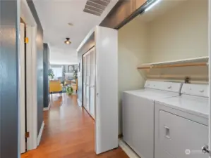 In unit utility room equipped with washer/dryer and shelving. Everything conveys.