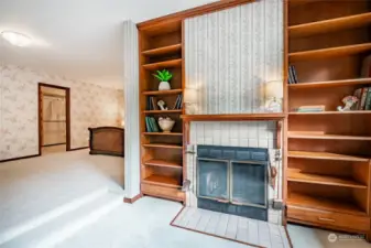 Wood fireplace and built in bookshelves complete this elegant room.