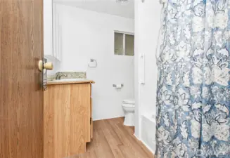 Full bath has nice laminate flooring.