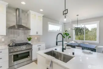 Commerical style Smart oven with gas cooktop. Photo is of the staged model, the same 2,958 sf floor plan as the listed home.  Colors vary.