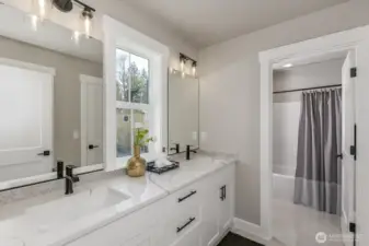 Upper hallway bath with large vanity & private shower room. Photo is of the staged model. Colors vary.