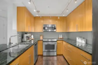 Spacious kitchen with high-end appliances, fashionable cabinets, granite counters.