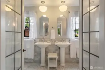 Leaded glass French doors lead to the ensuite bathroom