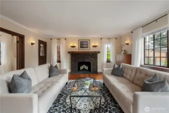 Spacious living room centers on restored wood burning fireplace