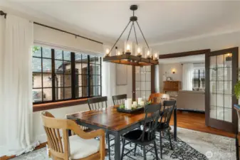 Leaded glass French doors lead to the formal dining room