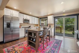 Plenty of room for a dining table. Table in the picture can stay.