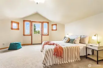 The generous primary bedroom features a large walk-in closet and a deck that opens onto your private patio with bay views.