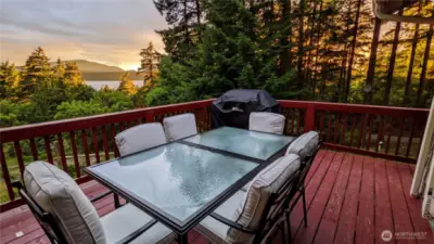 The glow of the summer sunset streaming through the trees and reflecting off of the sound