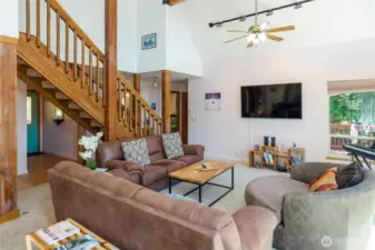 Stepping back into the living room from the deck, the front door is to your left, the main floor bath and two bedrooms are straight ahead