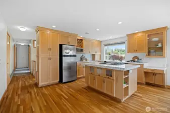 There is so much cabinetry storage in the the kitchen and even a pantry to the left of the refrigerator.