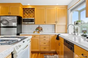 The kitchen has a wine rack above the microwave and an appliance garage with a tamboured door.