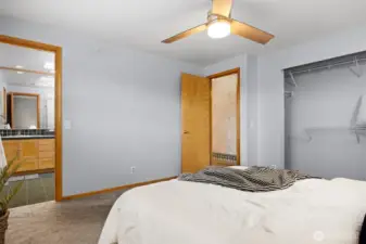 Looking toward the 3/4 bath off the primary bedroom with the closet and hallway across the room.