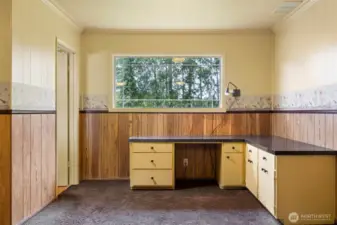 There is a built in desk at that alcove off the rec room, beside the half bath.