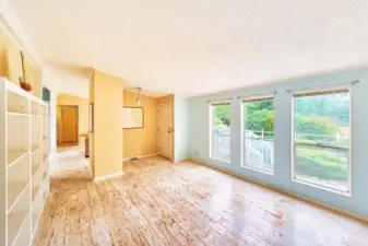 Enter to a "formal" living room with large windows looking out to the yard.