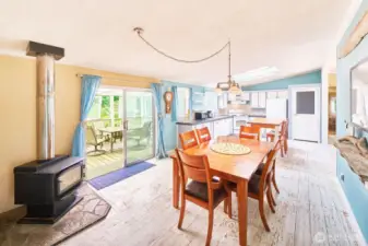 Dining area adjacent to kitchen, with slider to covered deck for indoor or outdoor dining.