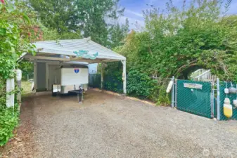 Carport expands your covered parking space. Back gate is covered with a living arch.