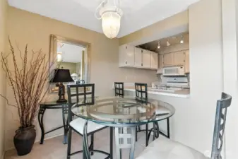 Dining room just off the living room open to the kitchen with breakfast bar.