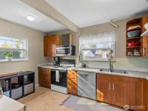 The updated kitchen has gorgeous mahogany maple cabinets and quartz counters.