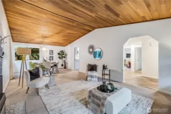 The living area extends to the dining room at the other end, blending the entertainment spaces seamlessly.