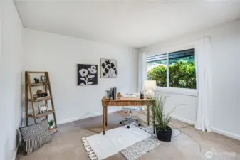 This main floor bedroom can serve as a home office or guest room. It looks out over the front yard.