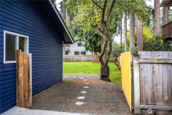 The side gate opens to the fully fenced, level backyard.