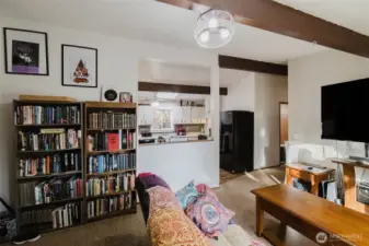 Notice the pass-through from the kitchen to the livingroom for added convenience.  The wooden beams in the ceiling add rustic charm.