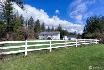 Spacious, level property with classic white rail fence framing lush green pasture.