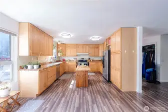 LARGE KITCHEN showcases generous cabinetry, butcher block counters and center island workspace.