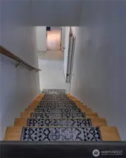 Convenient interior access to lower level, which sits at ground level ~ adding flexibility for additional living space, storage, or flexible-use areas.