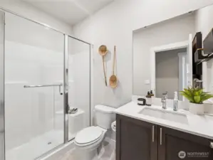 Main level bath has large walk-in shower.   Photo is representational. Actual home is under construction and finishes and colors will vary. See site agent for details.