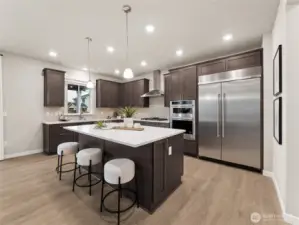 Gourmet Kitchen with upgraded appliances.   Check out the 48" included built-in Fridge. Photo is representational. Actual home is under construction and finishes and colors will vary. See site agent for details.