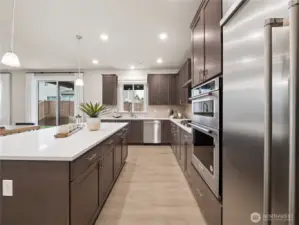 Another view of the spacious kitchen. Photo is representational. Actual home is under construction and finishes and colors will vary. See site agent for details.