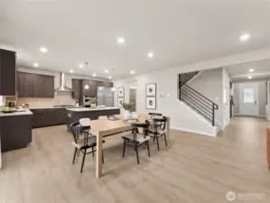 Looking towards the kitchen with eating space and staircase. Photo is representational. Actual home is under construction and finishes and colors will vary. See site agent for details.