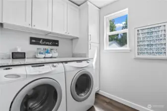 Laundry room with built in folding table and cabinets making chores a breeze!