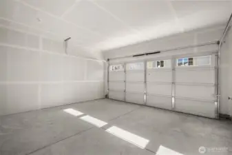 Spacious attached garage with a clean, finished look—ideal for parking, storage, or personal workshop space.