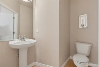 Half bath near kitchen, laundry & living spaces