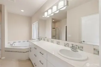 Primary bath, tile countertops and floor, double sinks, soaking tub.