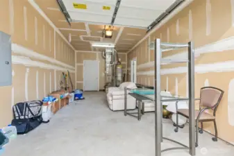 3 car garage.  This is this the 1 car side w/hot water heater, furnace, person door to back yard and separate garage door.