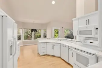 Generous kitchen area and cabinets. Tile countertops.  Eating bar plus room dining area.  Pantry.