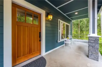 Covered front porch to enjoy the beautiful, natural setting.