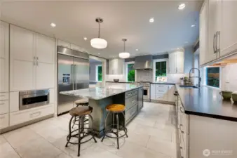 Thoughtfully designed commercial-style kitchen with plentiful storage and room to join in the action at the island.