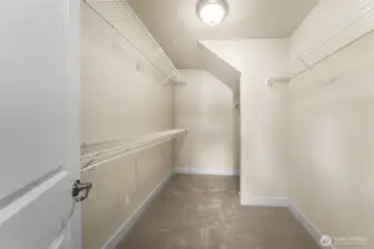Walk-in closet in primary ensuite.