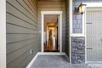 Enter under the covered front porch.