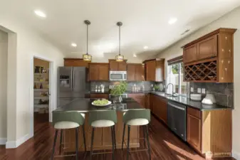 Kitchen w/ walk in pantry, bar area, motion sensor on the kitchen sink, wine rack and lots of cabinet space. (virtually staged)