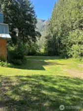 Area around outbuilding and below house