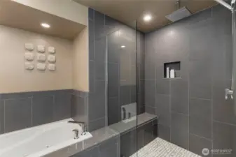 In the primary ensuite, enjoy this fabulous updated tub area and enormous shower with stylish rainshower fixture.