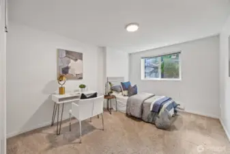 Comfortable bedroom with soft carpet and flexible space for work or study