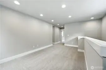 Head upstairs to the loft, laundry and bedrooms  photo of  completed home on another lot.